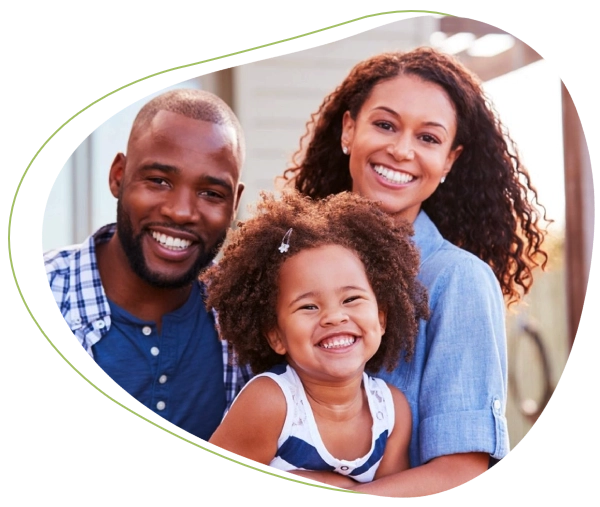 A family of three is smiling for the camera.