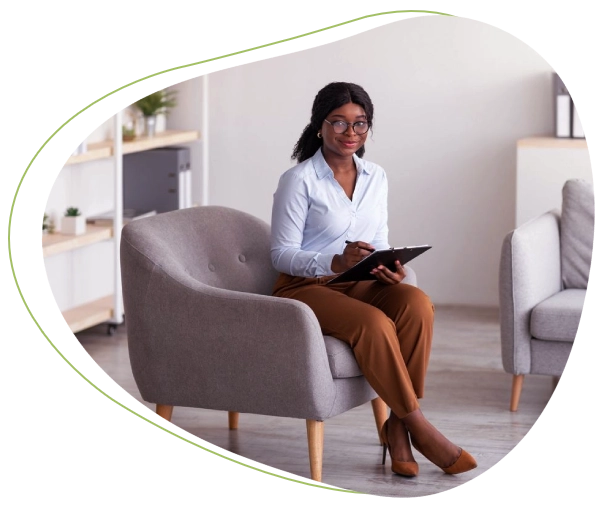 A woman sitting on top of a chair holding a tablet.