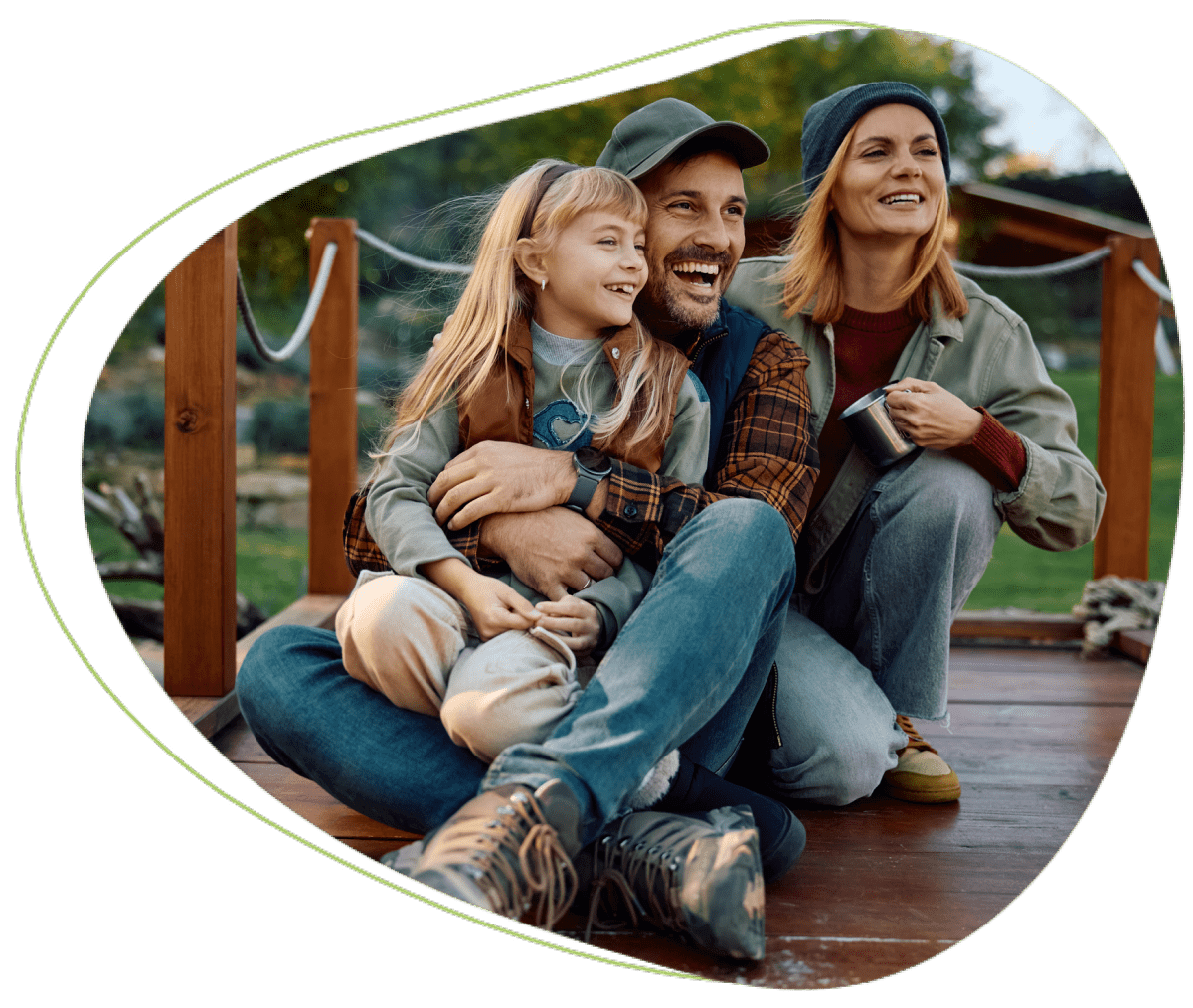 Happy family sitting outdoors on deck.